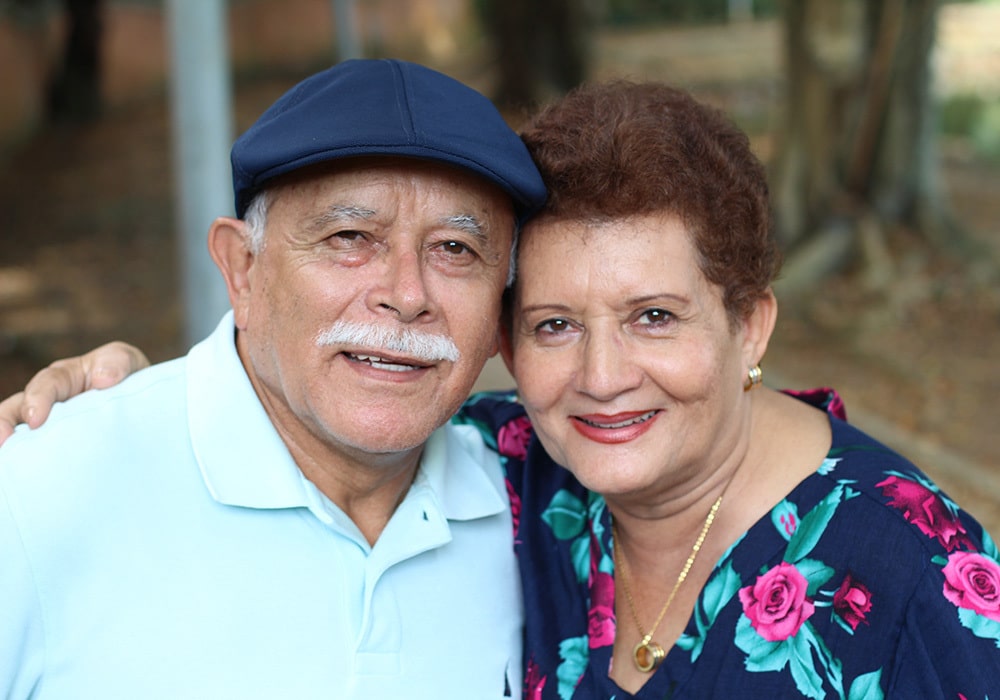 A couple outside smiling together.
