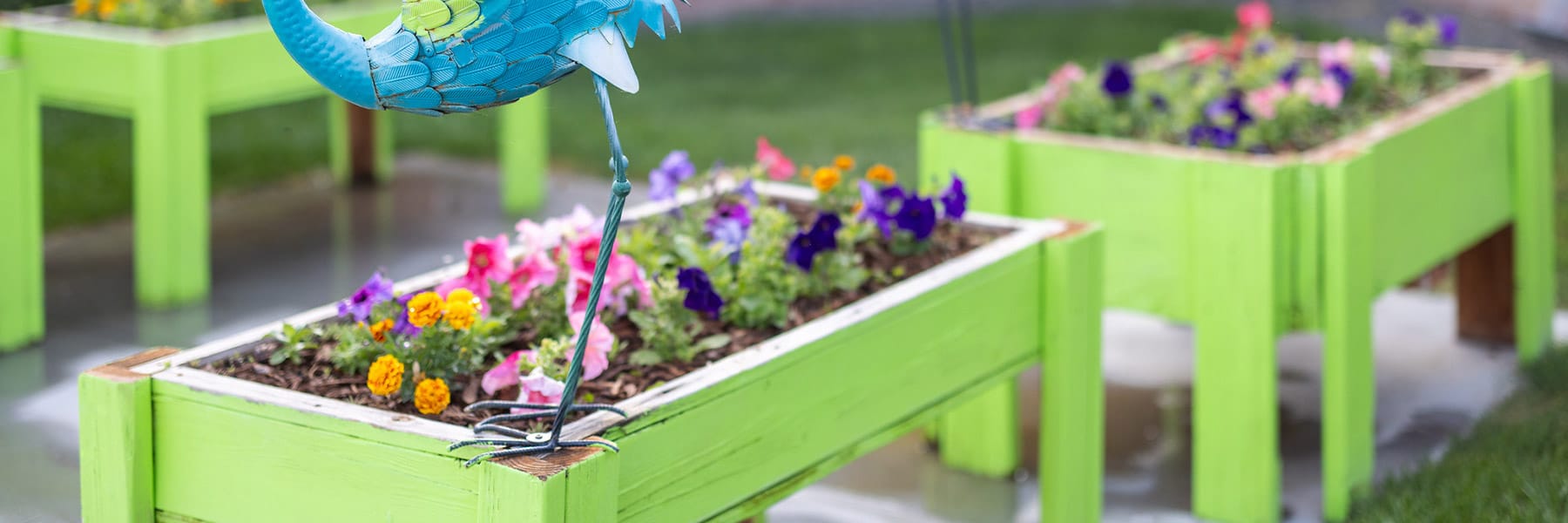 Flower beds with sculptures at Eagle Ridge Post Acute
