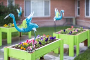 Flower beds with sculptures at Eagle Ridge Post Acute